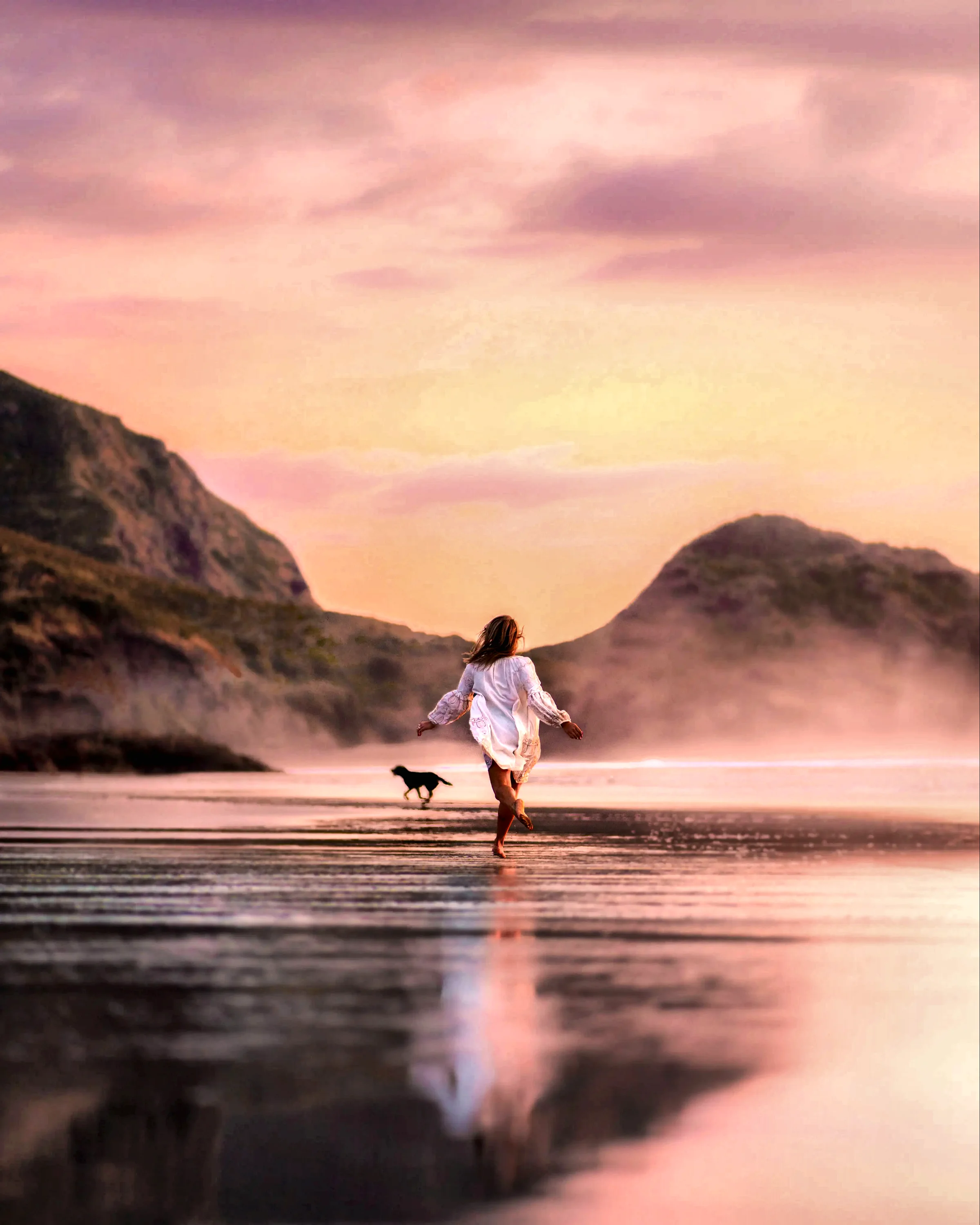 Woman walking a dog along the shore at dusk, anti-aging and functional medicine in Charleston